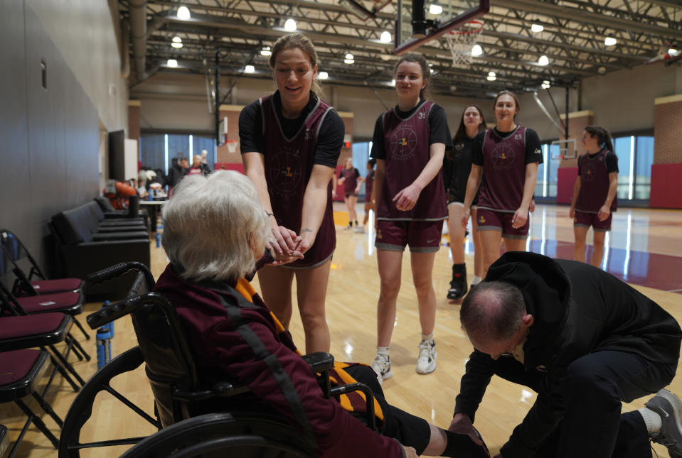 Loyola University women's basketball players greet Sister Jean Dolores Schmidt with a handshake after practice on Monday, Jan. 23, 2023, in Chicago. (AP Photo/Jessie Wardarski)