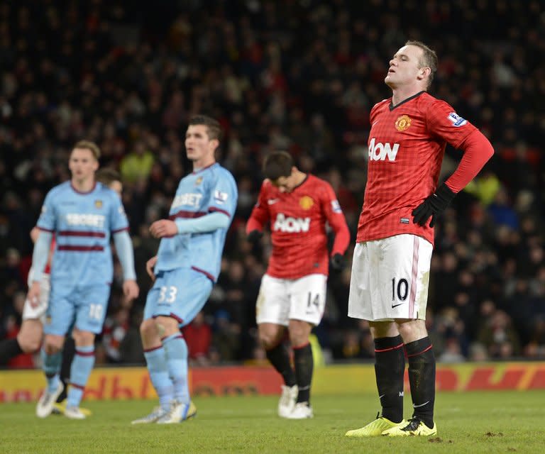 Manchester United striker Wayne Rooney reacts after missing his penalty kick during the third-round replay at home to West Ham United on January 16, 2013. Alex Ferguson called on his Manchester United side to improve their penalty-taking after Rooney's miss was their fifth spot-kick failure of the season