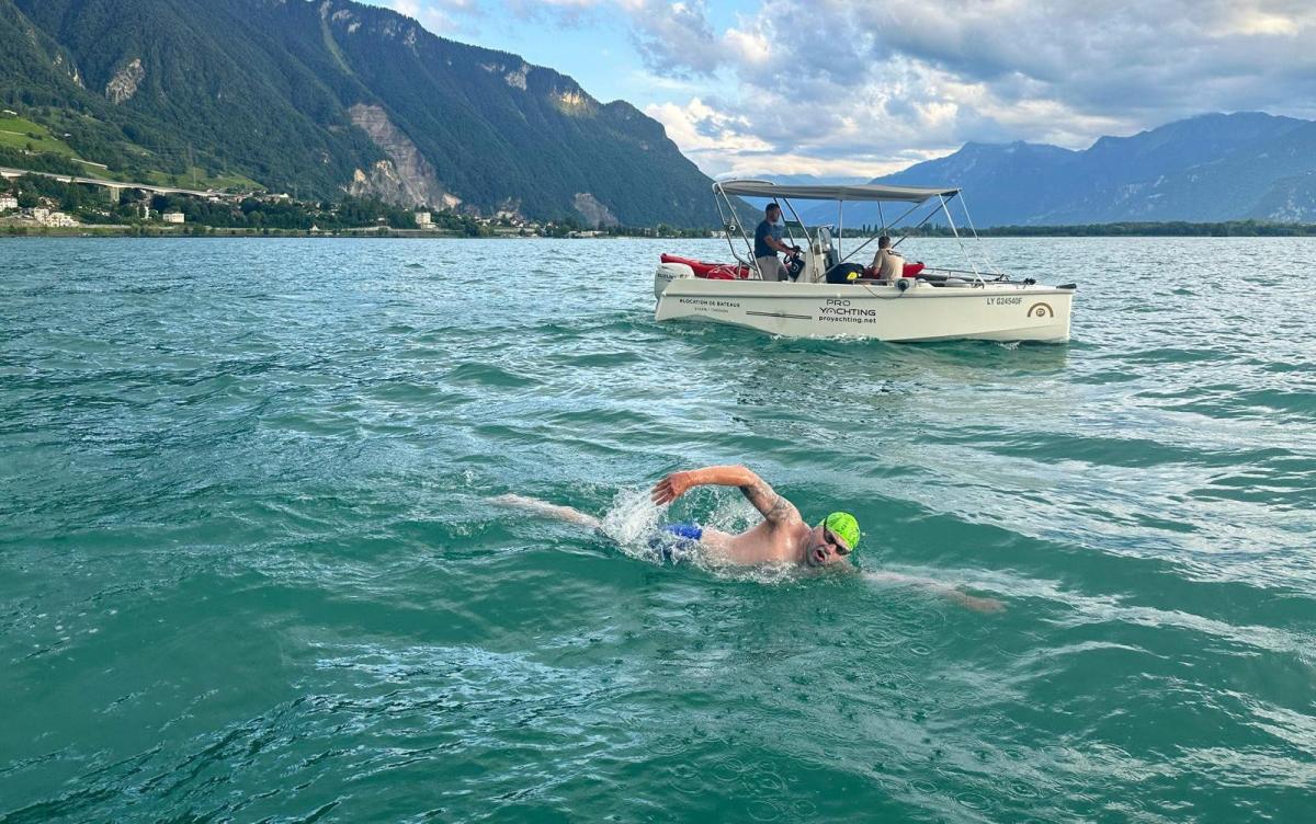 British man breaks 38-year record swimming across Lake Geneva in 22 hours – fuelled on doughnuts