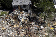Debris and rubble covers the ground in the aftermath of an explosion in Baltimore on Monday, Aug. 10, 2020. Baltimore firefighters say an explosion has leveled several homes in the city. (AP Photo/Julio Cortez)