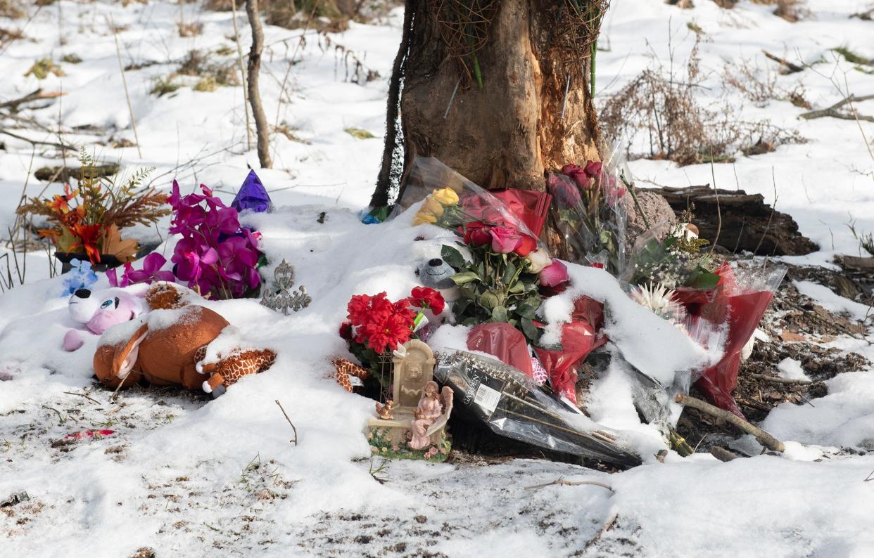 A roadside memorial was set up at the scene of a December 2020 single-vehicle crash that killed three passengers and injured several others. The vehicle's driver, Ravenna resident Julianne M. Shead, 42, is scheduled for a plea hearing on July 19.