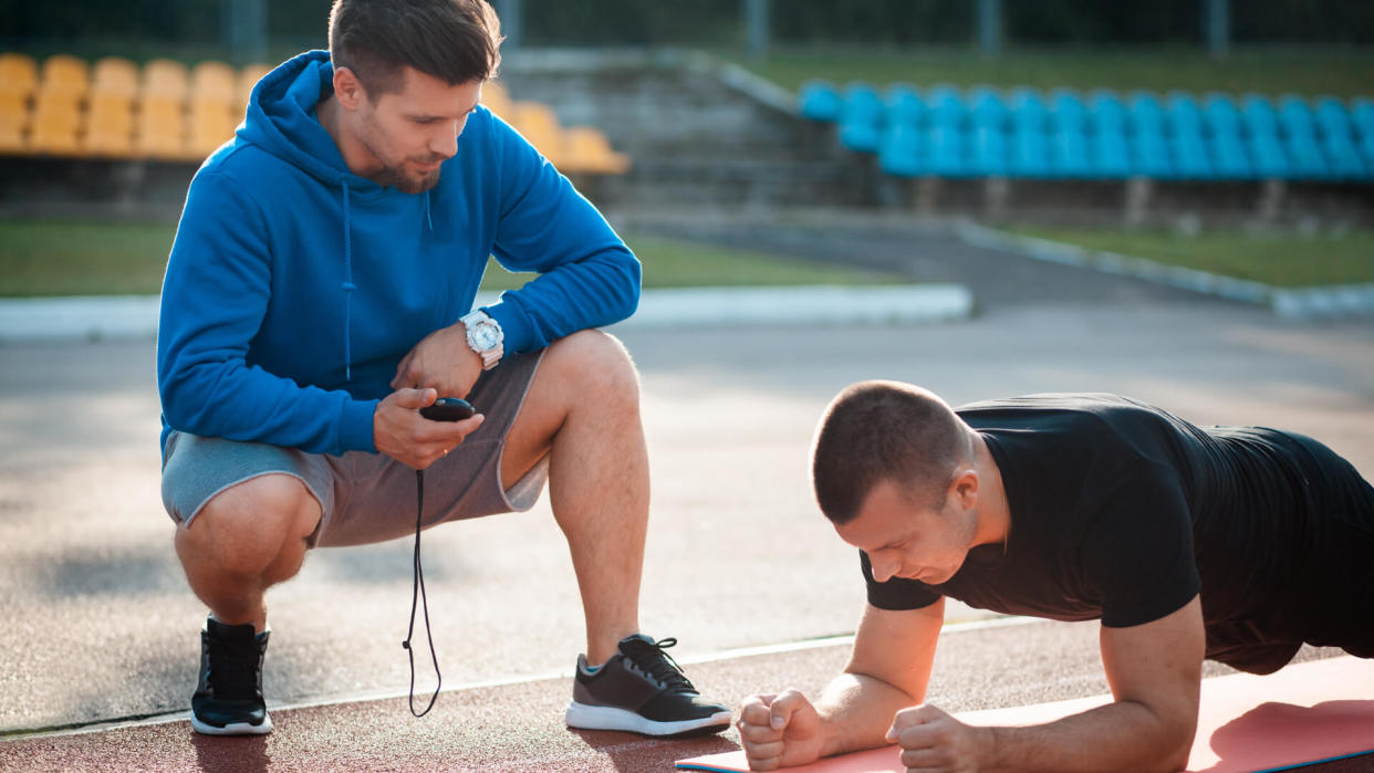 Athletic trainer helping an athlete at the track field