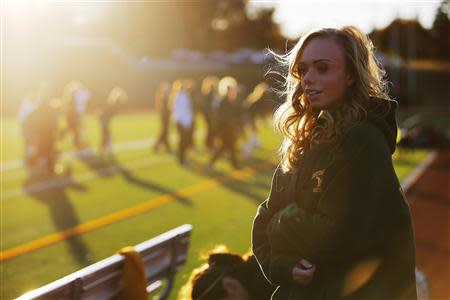 Seventeen year-old Hannah Steenhuysen watches her high school's girls soccer team prepare for a game against Bishop Feehan in Attleboro, Massachusetts October 25, 2013. REUTERS/Brian Snyder