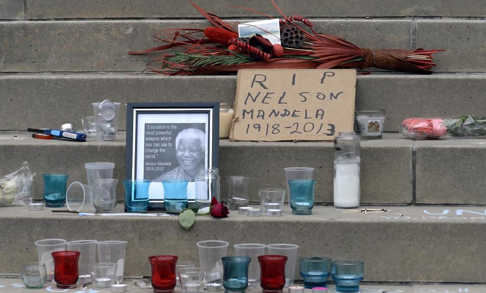 Candles and flowers are pictured on the front steps of Nelson Mandela Park Public School in Toronto