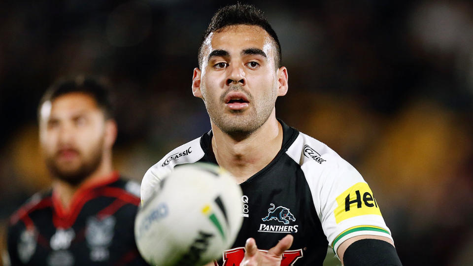 In this picture, Penrith Panthers star Tyrone May passes a ball during an NRL match.