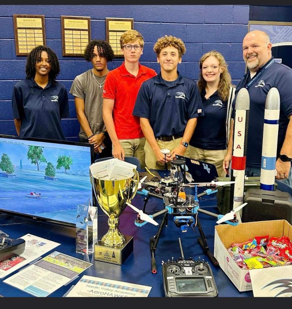 The AeroHawks team with their trophies, rockets, and drone at the freshman orientation night held at Hardin Valley Academy, August 2023. From left: Mickey Dandena, Khalil Ortiz, Trey Harvey, Zaen Grissino-Mayer, Bailey Mounts, Tim Smyrl (sponsor).