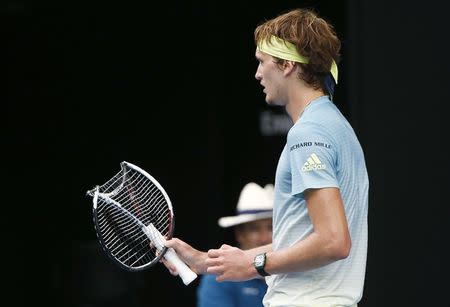 Tennis - Australian Open - Rod Laver Arena, Melbourne, Australia, January 20, 2018. Alexander Zverev of Germany holds his broken racquet during his match against Chung Hyeon of South Korea. REUTERS/Thomas Peter