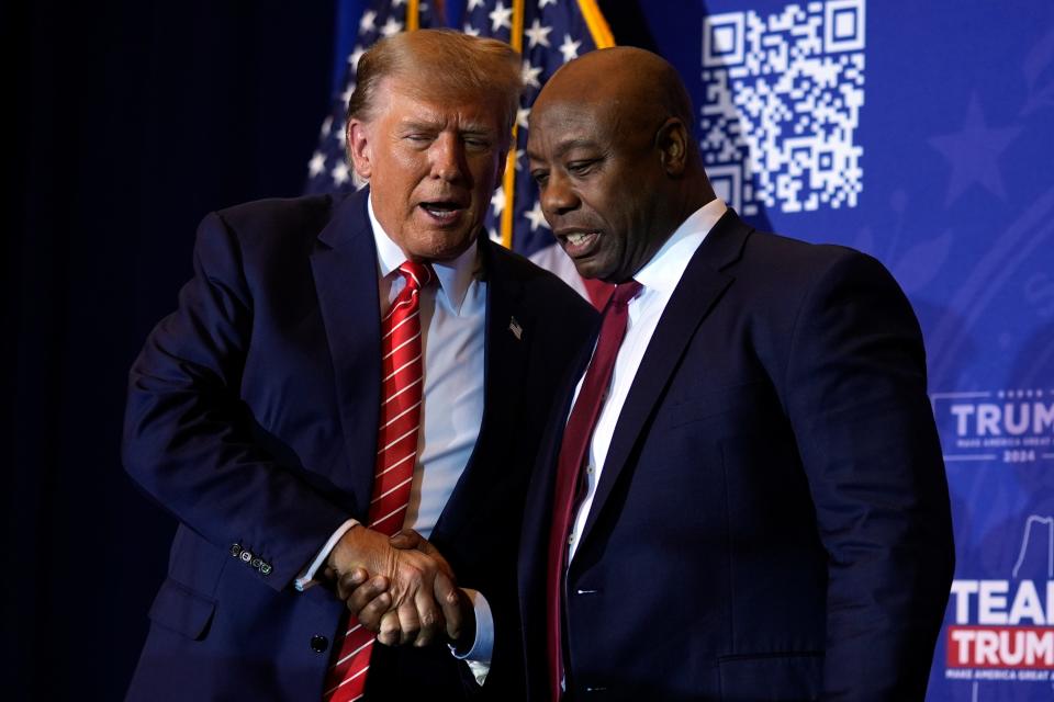 Republican presidential candidate former President Donald Trump shakes hands with Sen. Tim Scott, R-S.C., at a campaign event in Concord, N.H., Friday, Jan. 19, 2024. (AP Photo/Matt Rourke)