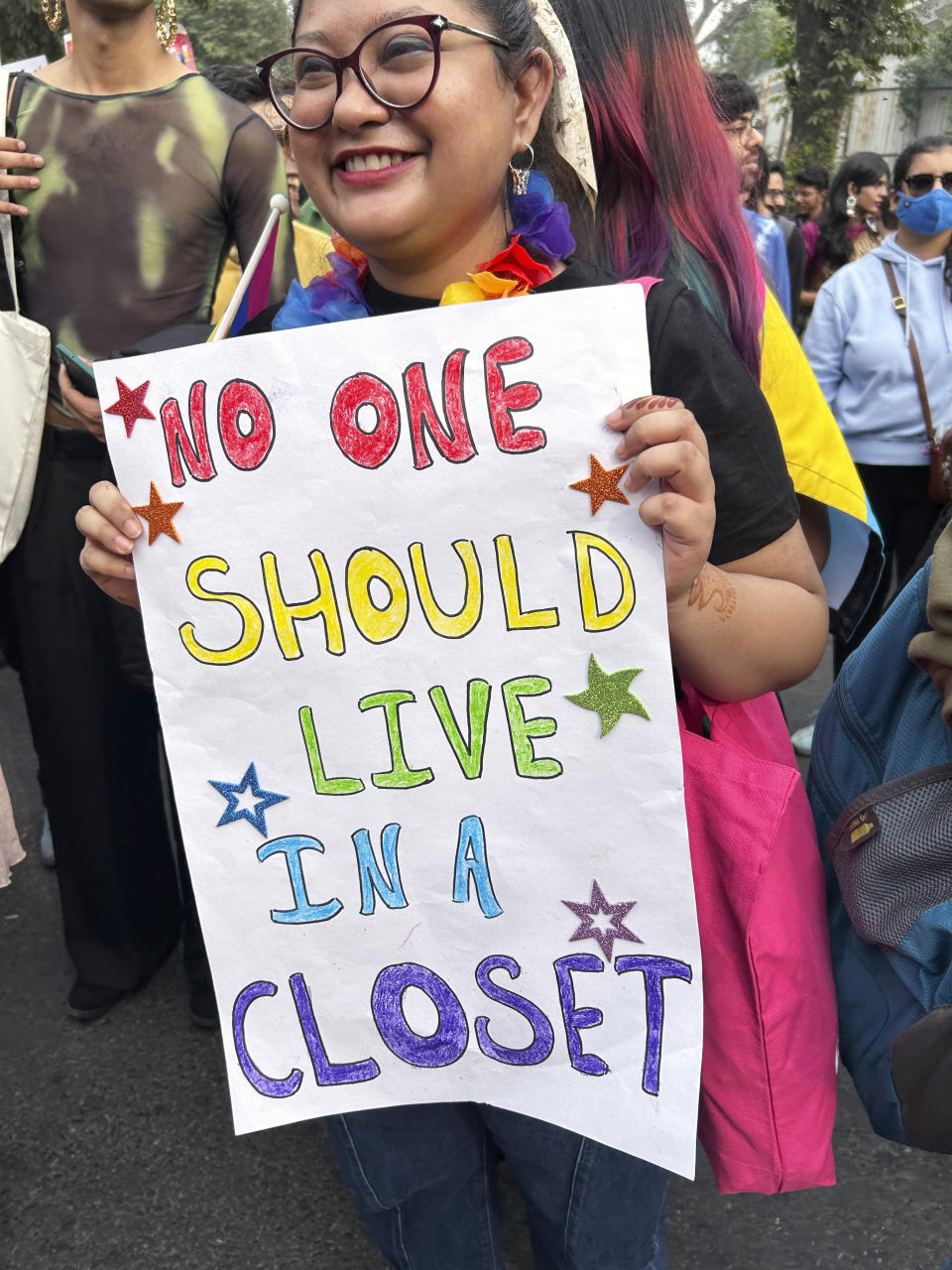 A participant of the Delhi Queer Pride Parade carries a placard saying 'No One Should Live in a Closet' during the march in New Delhi, India, Sunday, Nov. 26, 2023. This annual event comes as India's top court refused to legalize same-sex marriages in an October ruling that disappointed campaigners for LGBTQ+ rights in the world's most populous country. (AP Photo/Shonal Ganguly)