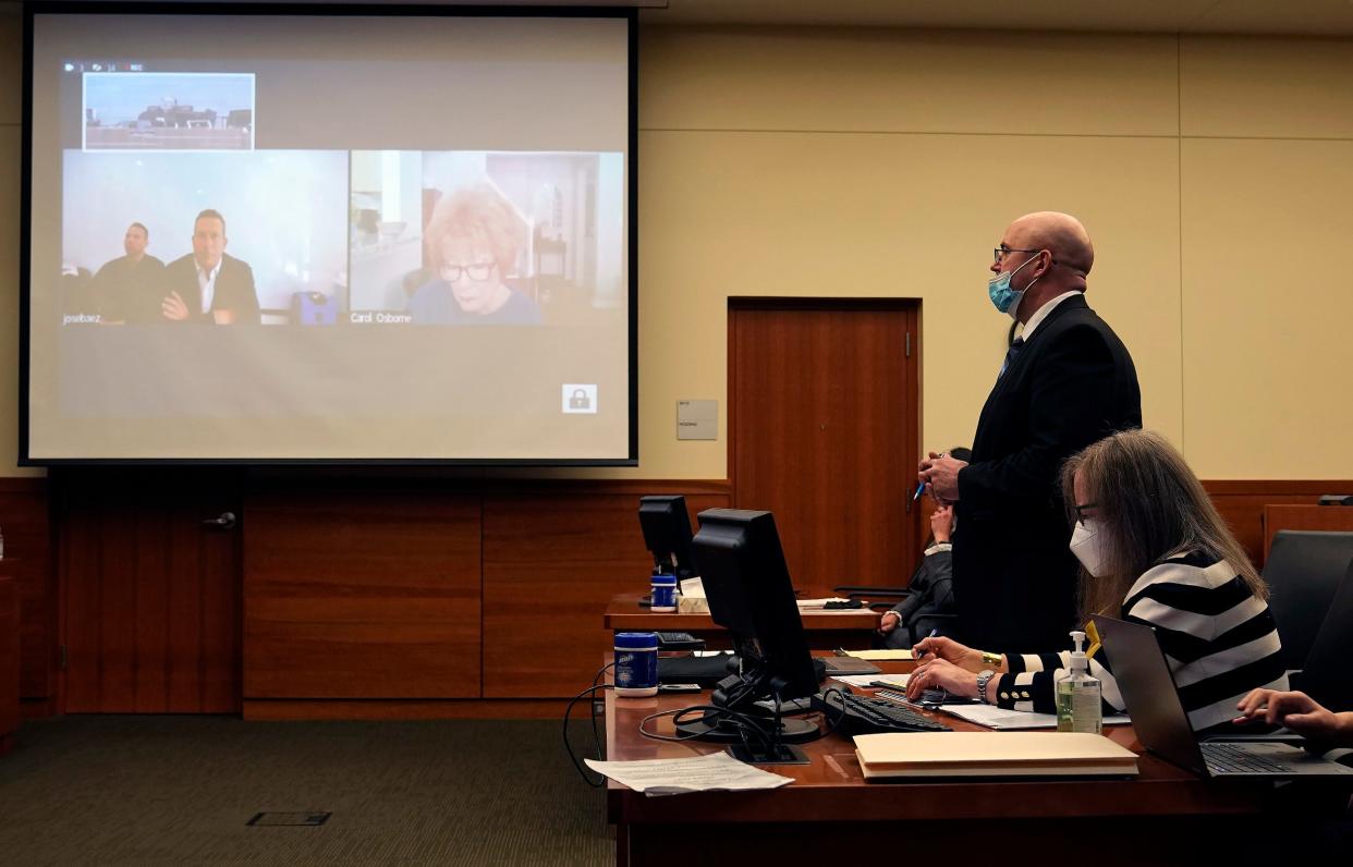 Assistant Franklin County Prosecutor David Zeyen speaks during a hearing Thursday at which prosecutors dismissed 11 counts of murder against former doctor William Husel, who was attending the meeting via a courtroom video screen (to the left) with defense attorney Jose Baez.
