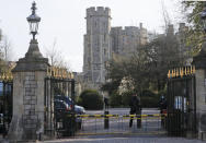 Armed police guards the entrance of Windsor Castle after the death of Britain's Prince Philip in Windsor, Sunday, April 11, 2021. Britain's Prince Philip, the irascible and tough-minded husband of Queen Elizabeth II who spent more than seven decades supporting his wife in a role that mostly defined his life, died on Friday. (AP Photo/Frank Augstein)
