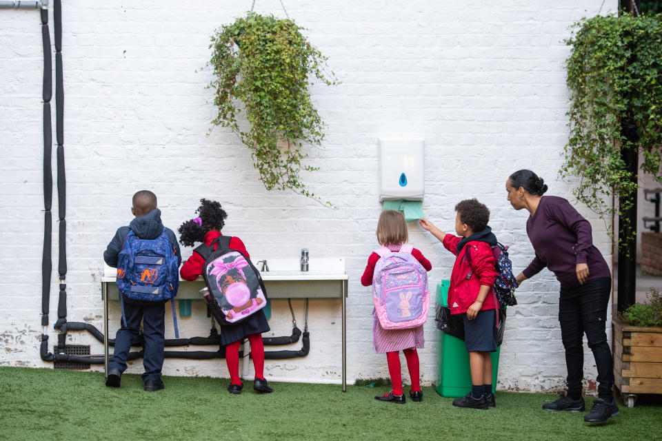 Pupils wash their hands as they arrive on the first day back to school at Charles Dickens Primary School in London, as schools in England reopen to pupils following the coronavirus lockdown. Approximately 40% of schools are expected to welcome back students for the start of the autumn term today, despite concerns being raised about their ability to reopen safely.