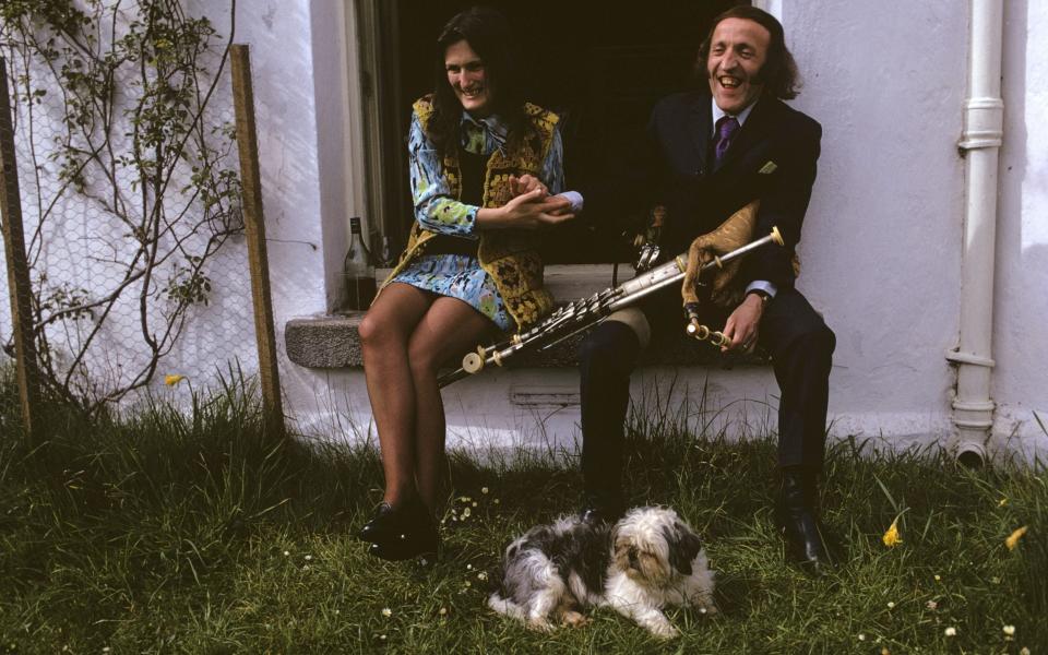 Paddy Moloney (holding his uilleann pipes) and his wife Rita O'Reilly share a laugh in Co Wicklow, June 1973 - Susan Wood/Getty Images