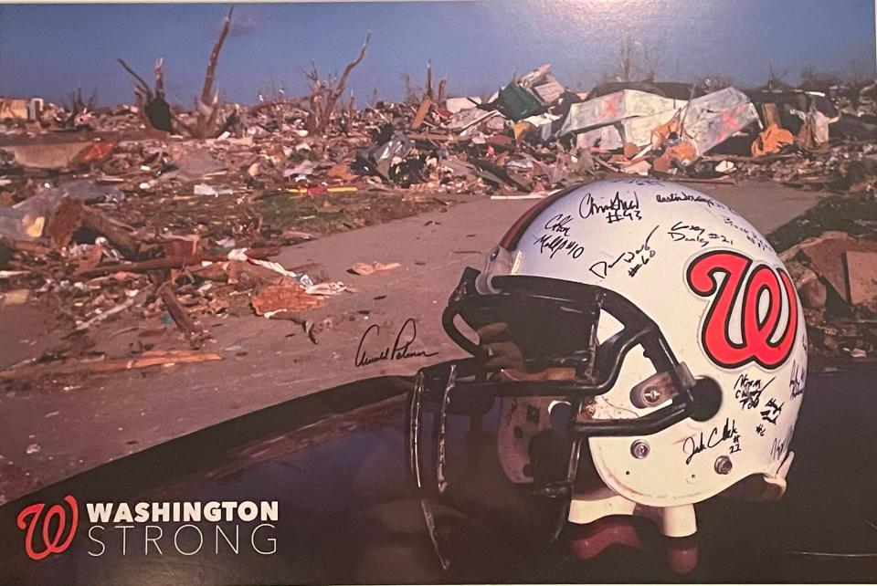 Washington head coach Darrell Crouch's prized keepsake is a poster picturing quarterback Colton Marshall's helmet amid the debris of his house after an EF-4 tornado hit the community on Nov. 17, 2013.