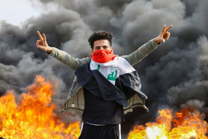 An Iraqi demonstrator gestures during the ongoing anti-government protests in Najaf