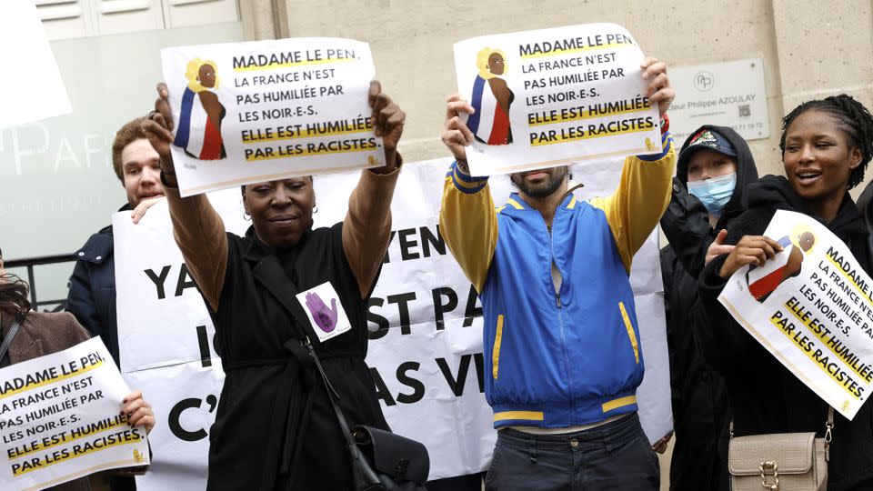 Demonstrators hold placards reading "Madame le Pen, France is not being humiliated by Blacks, it is being humiliated by racists" during a rally in front of the Rassemblement National (RN) headquarters, organised by the French association SOS Racisme in Paris on March 24, 2024, in support of Aya Nakamura. - Geoffroy Van Der Hasselt/AFP/Getty Images