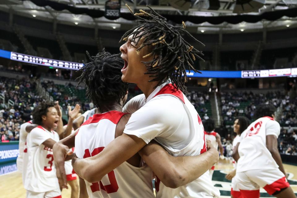 Flint Beecher guard Damarcus Burke Jr., left, hugs forward Wasir James after the 64-50 win in the Division 3 final at Breslin Center on Saturday, March 25, 2023.