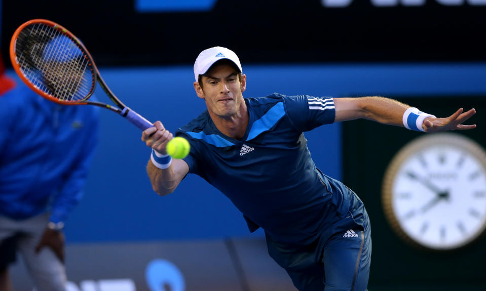 Andy Murray of Britain makes a forehand return to Roger Federer of Switzerland during their quarterfinal at the Australian Open tennis championship in Melbourne, Australia, Wednesday, Jan. 22, 2014.(AP Photo/Aaron Favila)