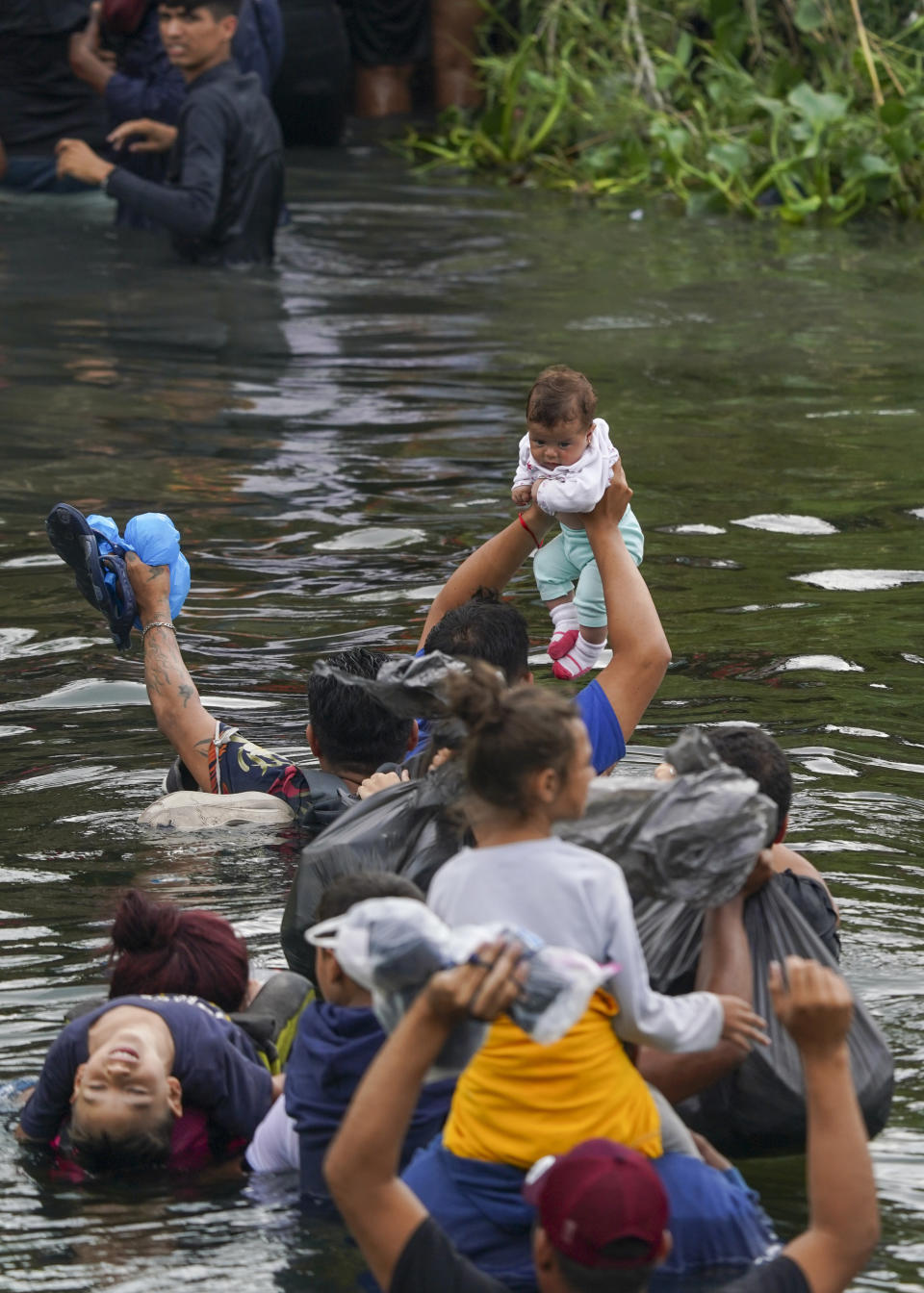 Migrants from El Salvador cross the Rio Grande river to the U.S. side, from Matamoros, Mexico, Thursday, May 11, 2023. Pandemic-related U.S. asylum restrictions, known as Title 42, are to expire May 11. (AP Photo/Fernando Llano)