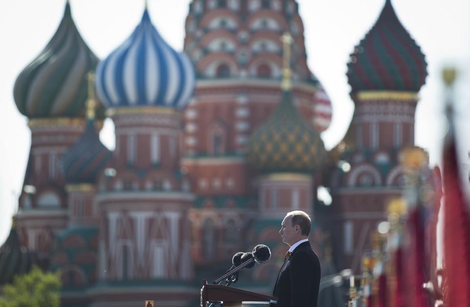 Russian President Vladimir Putin speaks during a Victory Day Parade, which commemorates the 1945 defeat of Nazi Germany, in Red Square, with St. Basil Cathedral in the background, in Moscow, Russia, Friday, May 9, 2014. Putin made no reference to the situation in Ukraine when he opened Friday's parade, focusing on the historic importance of the victory over Nazi Germany. (AP Photo/Pavel Golovkin)