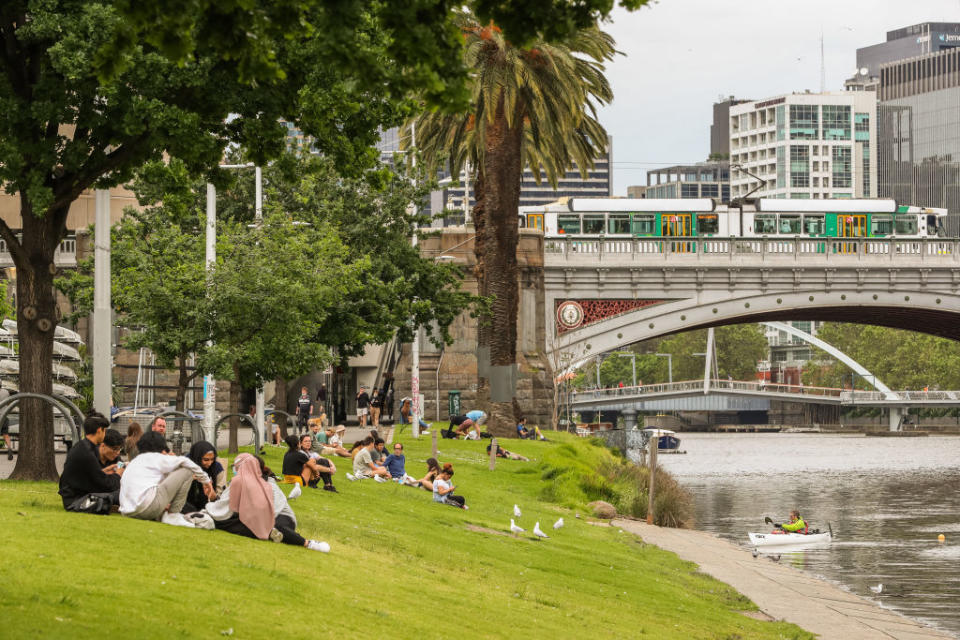 People are seen along the banks of the Yarra River  in Melbourne, Australia. 