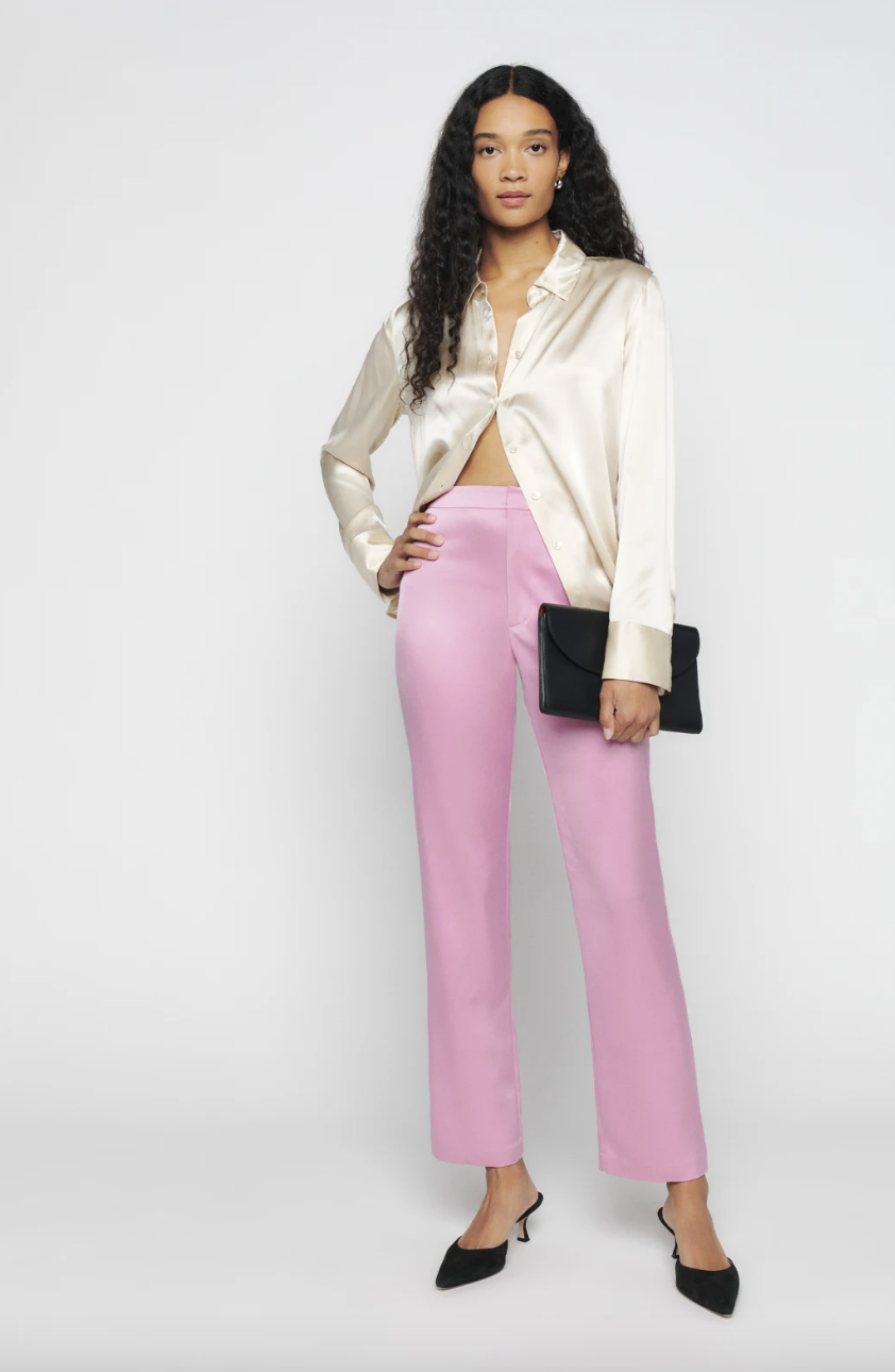 model wearing white silk shirt and pink Owen Pant (photo via Reformation)