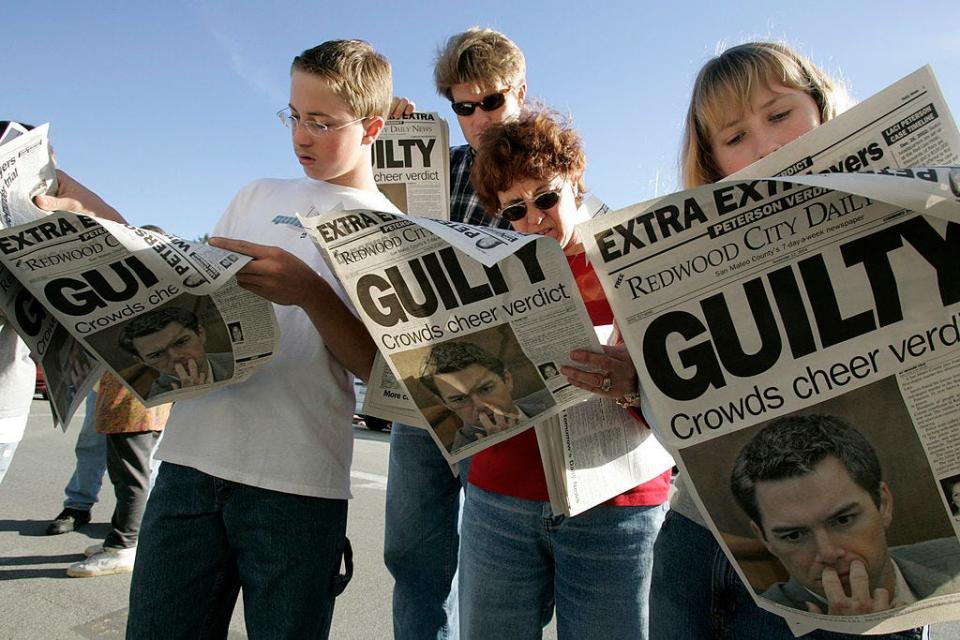 Twelve-year-old Danny Lewin, Geoff Shenk, Katherine Lewin and 12-year-old Katie Lewin, read Extra edition put out by the Redwood City Daily News after the verdict came in in the Scott Peterson murder trial on November 12, 2004, in Redwood City, California.