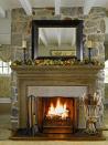 <p>For this stone fireplace, an autumn-themed garland of dried leaves and mini pumpkins makes for a subtle but effective decorating idea. Add a few pine cones to your log pile for an extra cozy touch. </p>