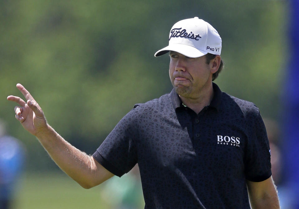 Erik Compton reacts after a birdie on the ninth hole during the opening round of the Zurich Classic golf tournament at TPC Louisiana in Avondale, La., Thursday, April 24, 2014. (AP Photo/Gerald Herbert)