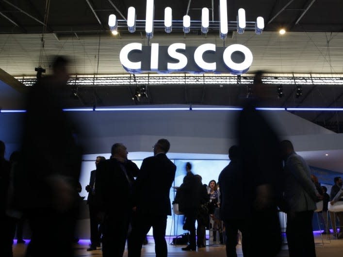 Visitors walk past Cisco's booth during Mobile World Congress in Barcelona, Spain, February 27, 2017. REUTERS/Paul Hanna 
