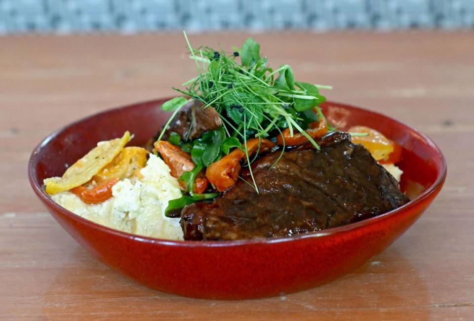 The southern IBC braised short rib at Gigi’s Southern Table. The dish features IBC root beer and sassafras infused short ribs served with Charleston grits and roasted tomatoes.