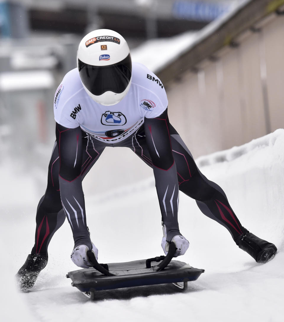 Martins Dukurs from Latvia crosses the finish line to win the men's Skeleton world cup competition in Winterberg, Germany, Friday, Jan. 7, 2022. (Caroline Seidel/dpa via AP)