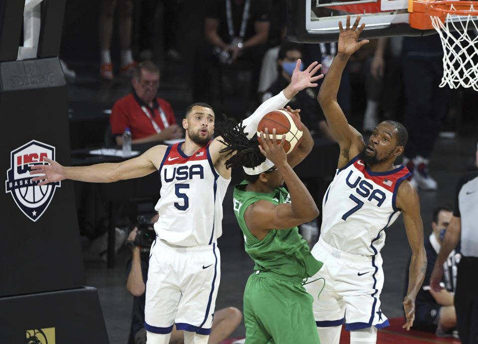 United States' Zach LaVine (5) and Kevin Durant (7) defend against Nigeria's Chima Moneke during an exhibition basketball game Saturday, July 10, 2021, in Las Vegas. (AP Photo/David Becker)