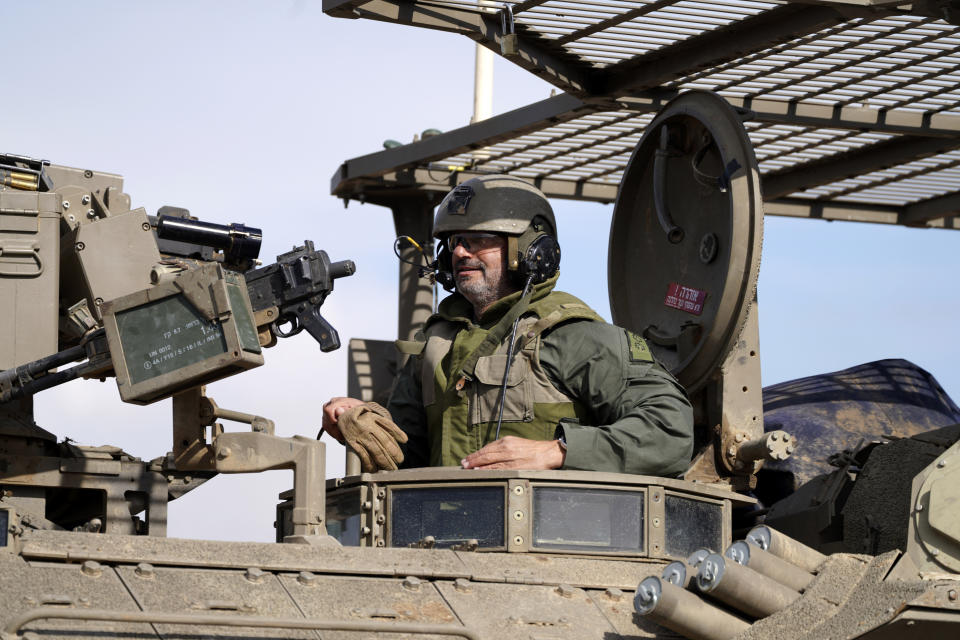 An Israeli soldier drives in an armored vehicle in southern Israel near the border with the Gaza Strip during ongoing ground operations, Friday, Feb. 2, 2024. (AP Photo/Tsafrir Abayov)