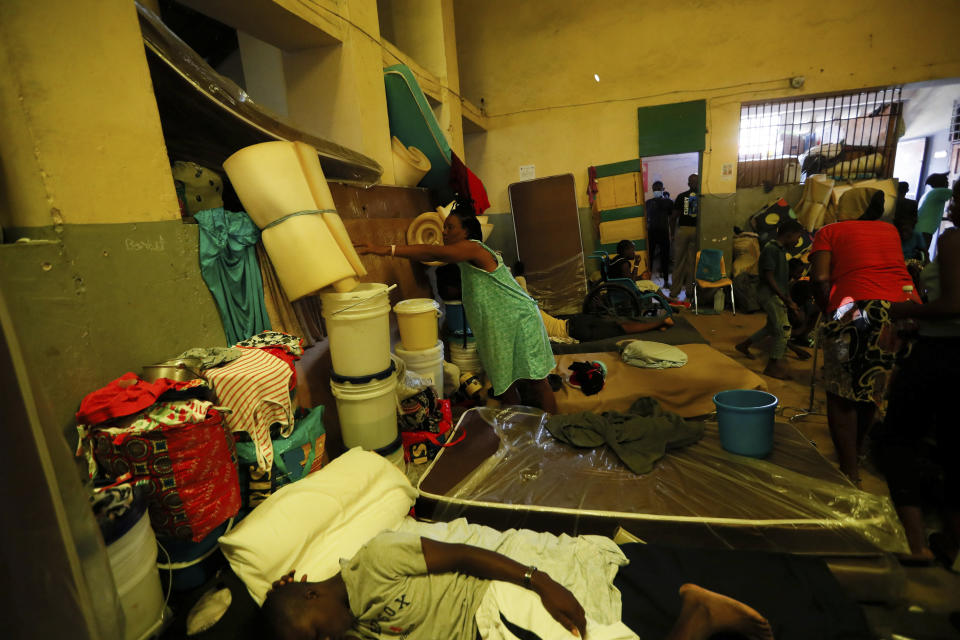 A woman shelves a foam mattress as she tides up her area at a shelter for displaced Haitians, in Port-au-Prince, Haiti, Saturday, July 10, 2021, three days after Haitian President Jovenel Moise was assassinated in his home. The displaced Haitians were forced to flee their community where they had settled after the 2010 earthquake, after armed gangs set their homes on fire in late June. (AP Photo/Fernando Llano)