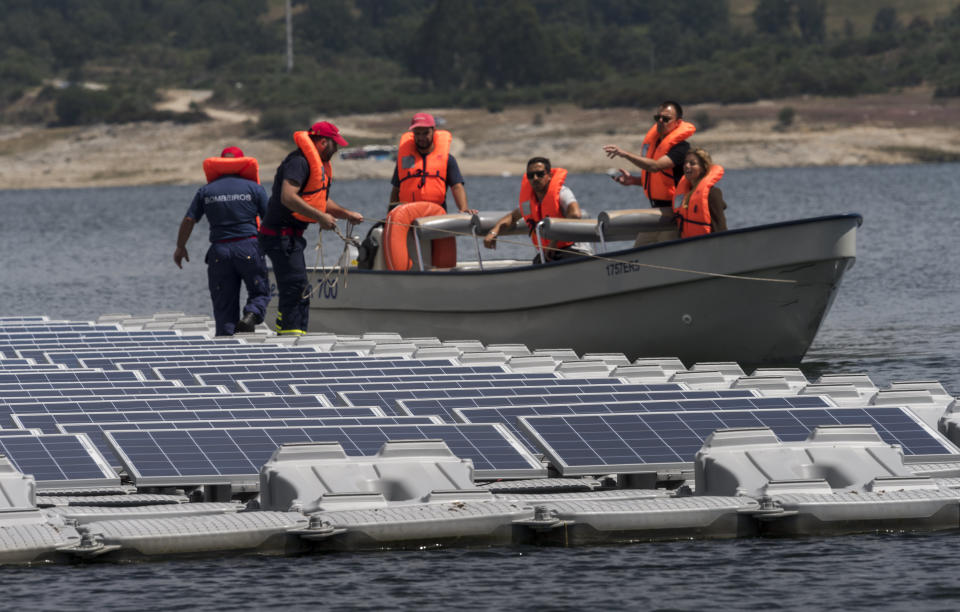 Workers access the panels by boat.