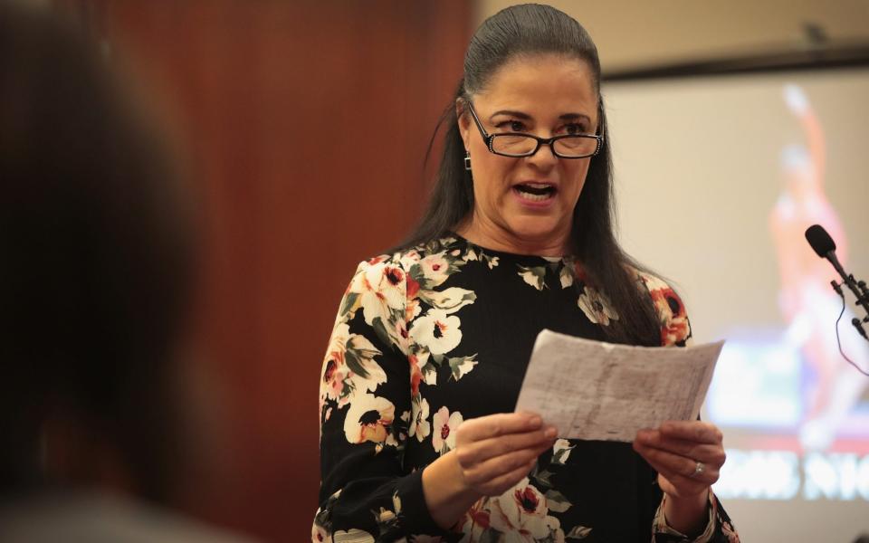 Nichols's mother, Gina, reads her daughter's victim statement in court in January 2018 - Scott Olson/Getty Images North America