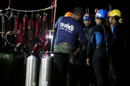 Thai divers gather before they enter to the Tham Luang cave, where 12 boys and their soccer coach are trapped, in the northern province of Chiang Rai, Thailand, July 6, 2018. REUTERS/Athit Perawongmetha