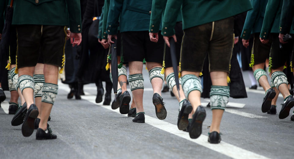 <p>People dressed in traditional Bavarian clothes walk the streets during a parade. (Reuters/Michael Dalder) </p>