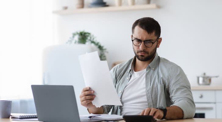 Man auditing his bank account for a tax levy