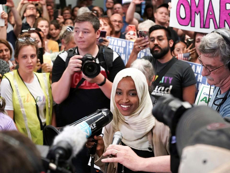 Ilhan Omar was greeted with cheers and “welcome home Ilhan” chants when she flew into her home state of Minnesota – a sharp contrast to the “send her back” shouts aimed at her at Donald Trump’s latest rally.Dozens of supporters greeted her at Minneapolis airport following an extraordinary week in which the president targeted her and three other Democratic congresswomen of colour in his now-notorious “go back” tweets.Ms Omar also received a standing ovation at an event on healthcare in Minneapolis on Thursday night, telling the packed crowd: “I know there are a lot of people that are trying to distract us now. But I want you all to know that we are not going to let them.”The Democratic congresswoman called Mr Trump a “fascist” an impromptu press conference earlier on Thursday. “This is what this president and his supporters have turned our country into,” Ms Omar said of the racist chants.“He’s spewing his fascist ideology on stage, telling US citizens to go back because they don’t agree with his detrimental policies for our country,” she added.Facing flak from Republicans on Thursday, Mr Trump tried to distance himself from his supporters’ cries at the North Carolina rally, saying “I felt a little bit bad about it”.He also claimed he had tried to stop the chanting on Wednesday night, despite video showing the crowd’s shouts resounded for 13 seconds as Mr Trump made no attempt to interrupt them.Asked why he failed to intervene, he said “I started speaking really quickly … I was not happy with it,” before saying he “would certainly try” to stop any similar chant at a future rally.As of Thursday, more than 40 of the 250 Republicans in Congress had criticised Mr Trump over his attacks on the congresswomen.Senator Mitt Romney, asked about the “send her back” chant, said, “It’s very unfortunate for our country ... And I’m glad the president has spoken out against it.”House minority leader Kevin McCarthy of California declared that the chant has “no place in our party and no place in this country”.Adam Kinzinger of Illinois tweeted that it was “ugly, wrong, & would send chills down the spines of our Founding Fathers. This ugliness must end, or we risk our great union”.And Mark Walker of North Carolina – a conservative who attended Mr Trump’s rally – was more circumspect, despite calling the chant “offensive”.Suggesting his objections were more strategic, he told reporters that the “send her back” slogan “does not need to be our campaign call like we did ‘Lock her up’ last time”.