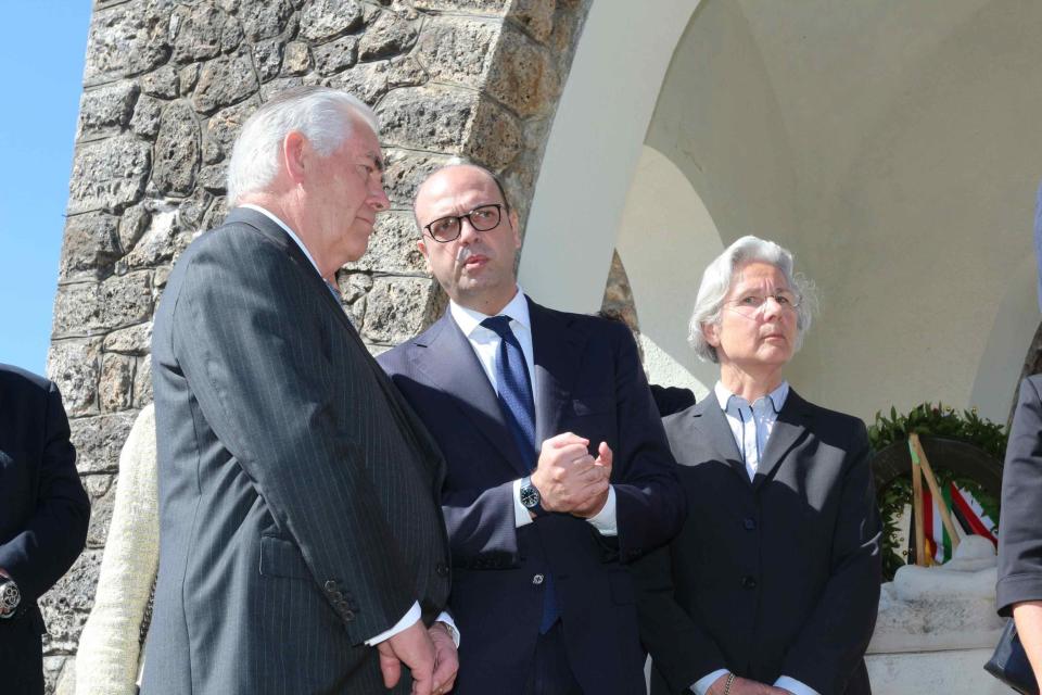 U.S. Secretary of State Rex Tillerson, left, and Italian Foreign Minister Angelino Alfano, left, stand after laying a wreath at a memorial in Santa' Anna di Stazzema, a site of Nazi atrocities where 560 civilians, including some 130 children, were killed during World War II, Monday, April 10, 2017. Tillerson said Monday that the United States is rededicating itself to hold to account "any and all" who commit crimes against innocent people. Foreign ministers from the Group of Seven industrialized nations are gathering in Lucca for a meeting given urgency by the chemical attack in Syria and the U.S. military response, with participants aiming to pressure Russia to end its support for President Bashar Assad. (Riccardo Dalle Luche/ANSA via AP)