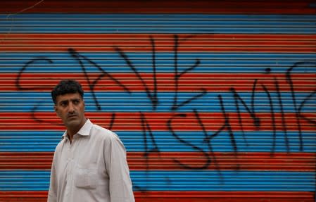 Kashmiri man waits before Eid-al-Adha prayers during restrictions after the scrapping of the special constitutional status for Kashmir by the Indian government, in Srinagar