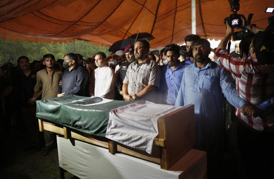 People attend the funeral prayer for Pakistani nuclear scientist Abdul Qadeer Khan, in Islamabad, Pakistan, Sunday, Oct. 10, 2021. Khan, a controversial figure known as the father of Pakistan's nuclear bomb, died Sunday of COVID-19 following a lengthy illness, his family said. He was 85. (AP Photo/Anjum Naveed)