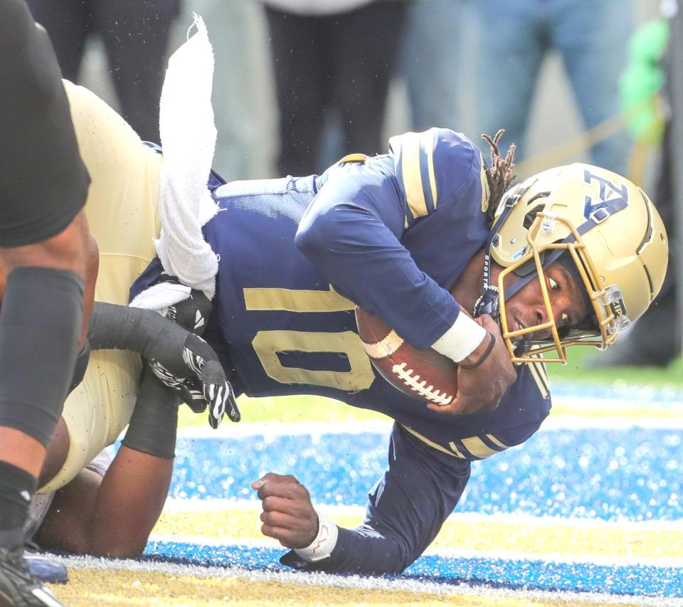 University of Akron quarterback Tahj Bullock scores a first-quarter touchdown against NIU on Saturday in Akron.