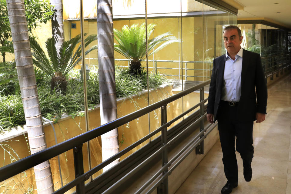 Fugitive ex-auto magnate Carlos Ghosn arrives for an interview with The Associated Press, in Dbayeh, north of Beirut, Lebanon, Tuesday, May 25, 2021. The embattled former chairman of the Renault-Nissan-Mitsubishi alliance dissected his legal troubles in Japan, France and the Netherlands, detailed how he plotted his brazen escape from Osaka, and reflected on his new reality in crisis-hit Lebanon, where he is stuck for the foreseeable future. (AP Photo/Hussein Malla)