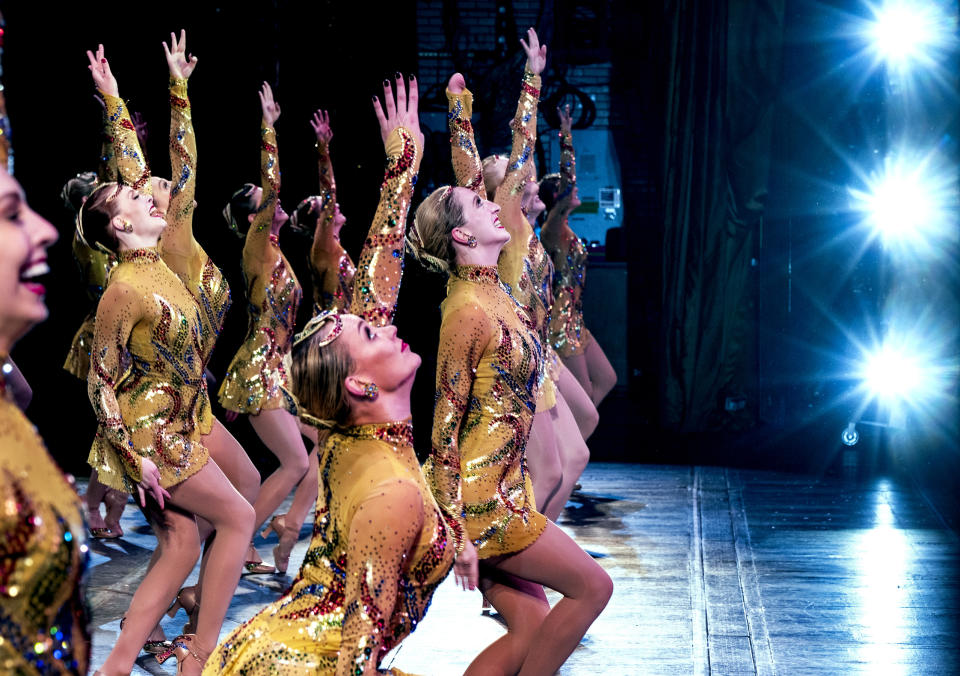 In this Monday, Nov. 25, 2019 photo, Rockette Sydney Mesher, front center, dances during a performance of the Christmas Spectacular at Radio City Music Hall in New York. Mesher, who was born without a left hand due to the rare congenital condition symbrachydactyly, is the first person with a visible disability ever hired by New York's famed Radio City Rockettes. (AP Photo/Craig Ruttle)