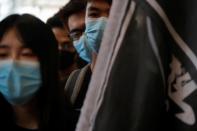 Students at Hong Kong Baptist University take part in a rally after police entered the campus on Sunday while chasing protesters, in Hong Kong