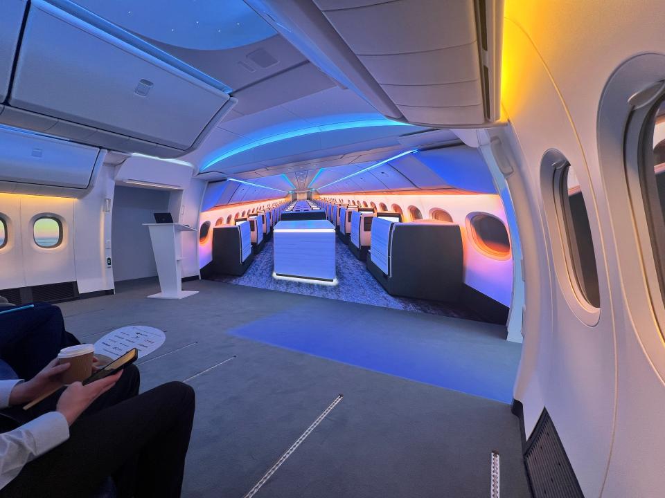 A business-class array displayed on the screen in a 777X cabin mockup