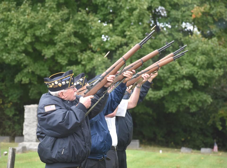 Members of American Legion Post 97 in Adrian fire a rifle salute Saturday during a monument dedication ceremony in Weston Village Cemetery. A new, 6-foot tall, granite monument now stands in the cemetery memorializing veterans of the Revolutionary War.